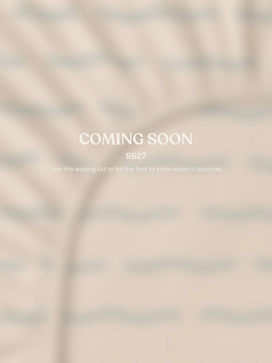 A beige fitted sheet blurred with centered text reading 'COMING SOON' and smaller text 'SS27 Join the waiting list to be the first to know when it launches.'.