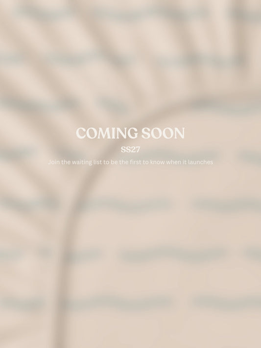 A beige fitted sheet blurred with centered text reading 'COMING SOON' and smaller text 'SS27 Join the waiting list to be the first to know when it launches.'.