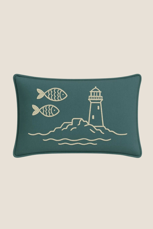 A rectangular teal cushion featuring a cream-colored embroidered design of the FastNet Rock.