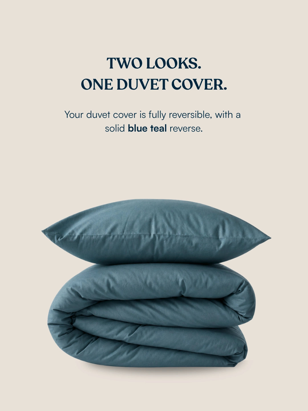 A folded duvet cover and matching pillow in a muted blue-teal color on a light beige background, with text above reading 'TWO LOOKS. ONE DUVET COVER.