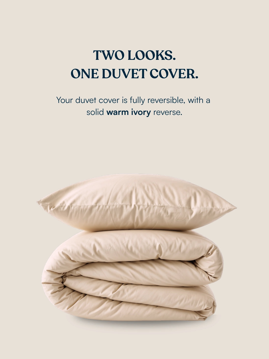 A folded beige organic cotton duvet cover on a warm cream background, with text above reading 'TWO LOOKS. ONE DUVET COVER.