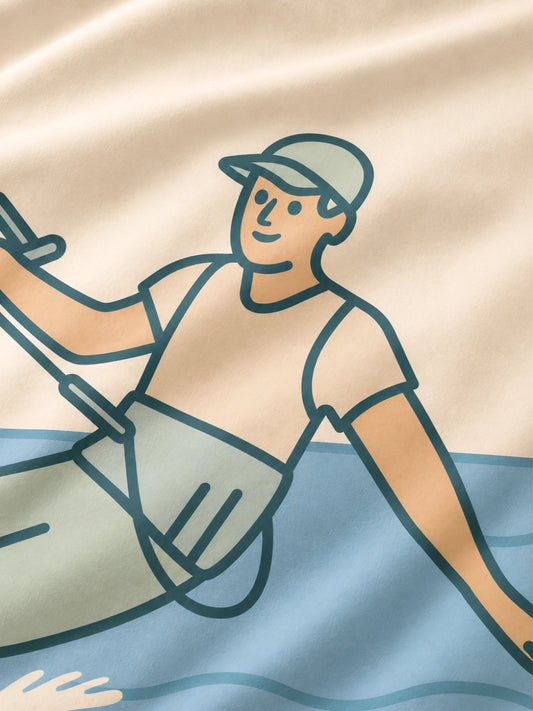 A close-up of a beige organic cotton duvet cover with a minimalist line-art illustration of a kitesurfer.